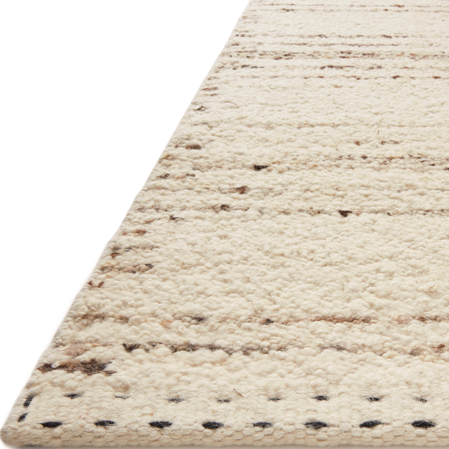 A perfect blend of refined and relaxed, the Roman Ivory / Pebble ROM-02 rug from Loloi is hand woven of wool, cotton and viscose by skilled artisans. Designs with meticulously placed strokes elevate any area such as an entryway, living room, dining room, or bedroom. Each piece is finished with a unique stitched edge. Amethyst Home provides interior design, new construction, custom furniture, and rugs for the Kansas City metro area.