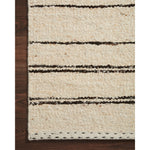 A perfect blend of refined and relaxed, the Roman Natural / Charcoal ROM-04 rug from Loloi is hand woven of wool, cotton and viscose by skilled artisans. Designs with meticulously placed strokes elevate any area such as an entryway, living room, dining room, or bedroom. Each piece is finished with a unique stitched edge. Amethyst Home provides interior design, new construction, custom furniture, and rugs for the Des Moines and Cedar Rapids, Iowa metro area.