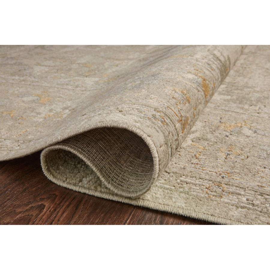 Durable, low pile, and soft, this rug is inspired by classic vintage and antique rugs. The Rosemarie Chris Loves Julia Ivory / Natural ROE-02 rug from Loloi features a beautiful vintage pattern and patina. The rug is easy to clean, never sheds, and perfect for living rooms, dining rooms, hallways, and kitchens!