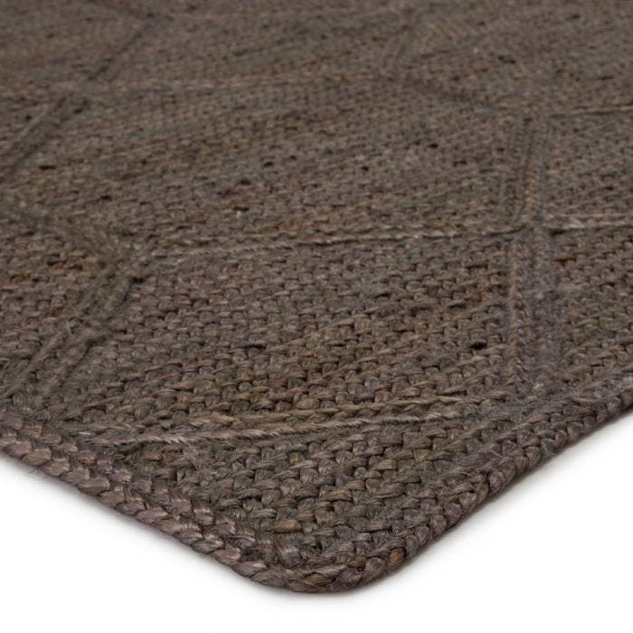 The Naturals Tobago collection delivers rich texture and organic allure to contemporary homes. Handwoven of jute, the Ponce area rug showcases a chic geometric trellis design. The mix of gray, taupe, and brown hues lend a deep natural tone to ground any space.  Handwoven  100% Jute  NAT42 Naturals Tobago Ponce Rug