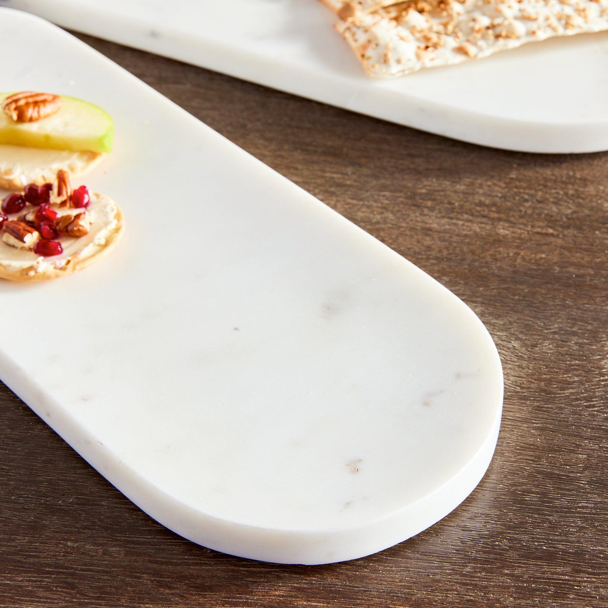 Sleek and simple, this set of oval marble trays are a great addition to any kitchen. An elegant way to serve guests an array of cheese, crackers & fruit. Amethyst Home provides interior design, new construction, custom furniture, and area rugs in the San Diego metro area.