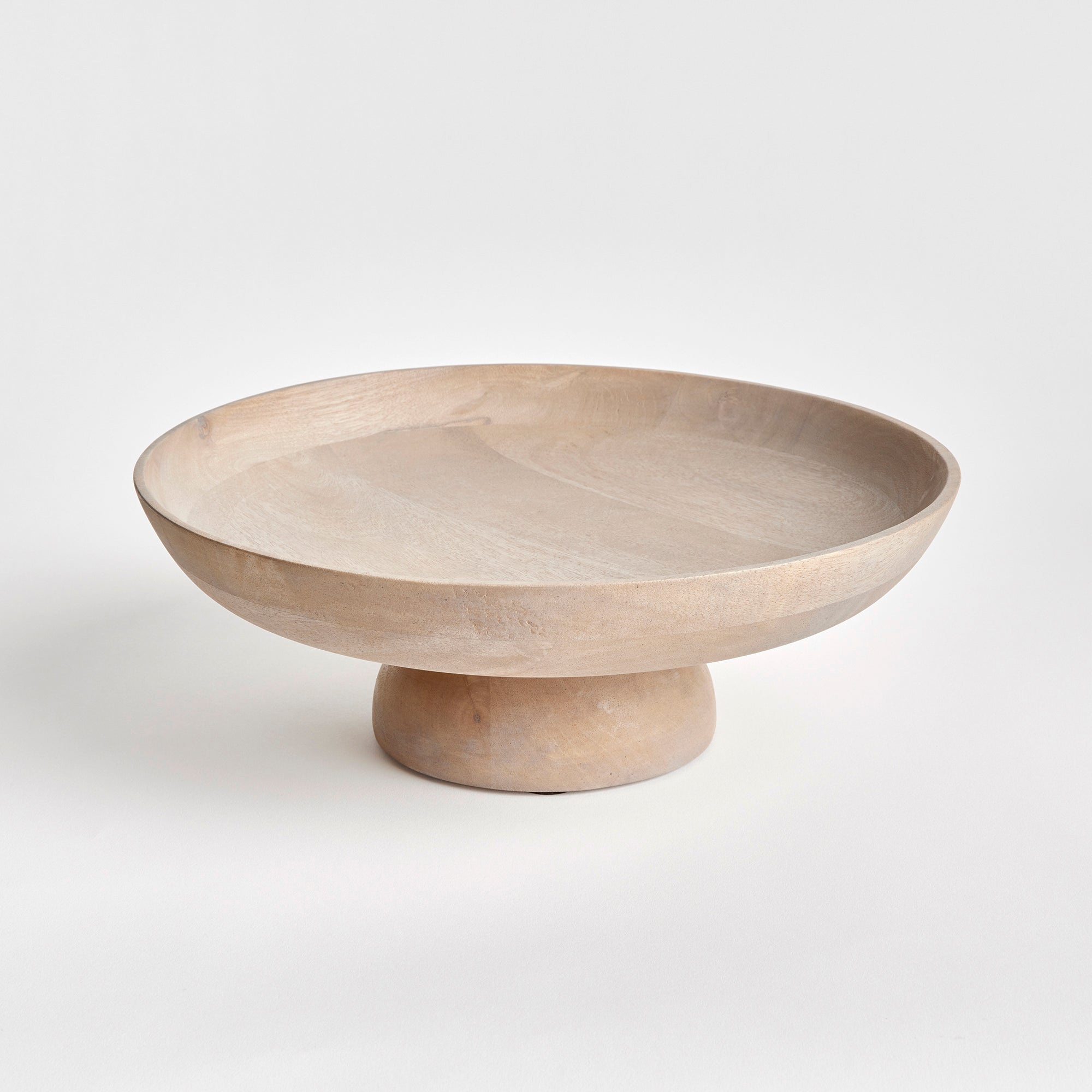 Contemporary and uniquely designed, this footed bowl is made of mango wood. Makes a beautiful serving bowl for dry foods, as well as a gorgeous centerpiece all on its own. Amethyst Home provides interior design, new construction, custom furniture, and area rugs in the Laguna Beach metro area.