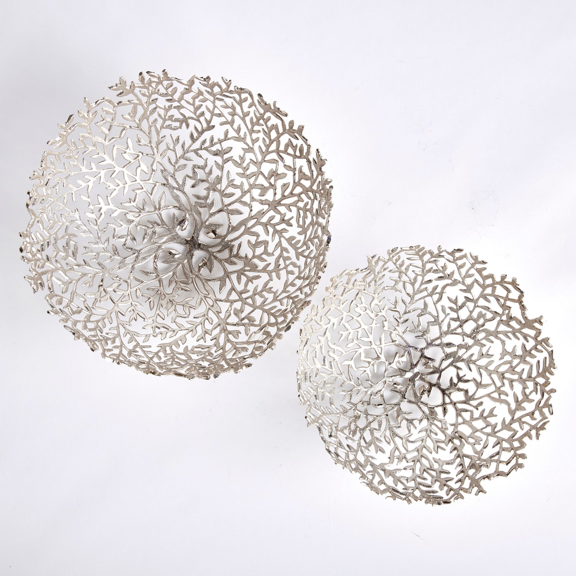 Light flowing vines make up the composition of this pair of silver decorative bowls. Fill with natural green orbs, or display as is for a clean, sophisticated look. Amethyst Home provides interior design, new construction, custom furniture, and area rugs in the Alpharetta metro area.