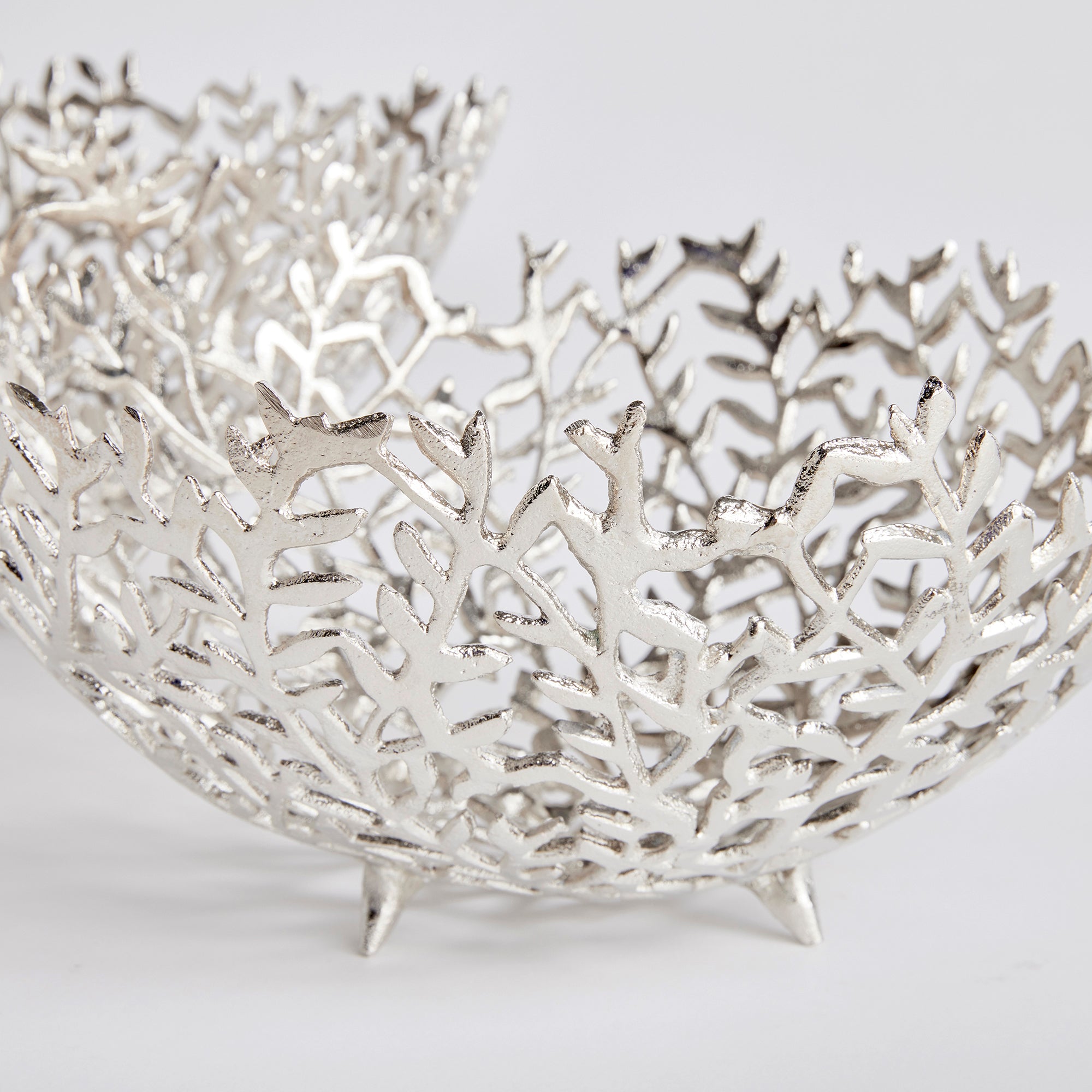 Light flowing vines make up the composition of this pair of silver decorative bowls. Fill with natural green orbs, or display as is for a clean, sophisticated look. Amethyst Home provides interior design, new construction, custom furniture, and area rugs in the Scottsdale metro area.