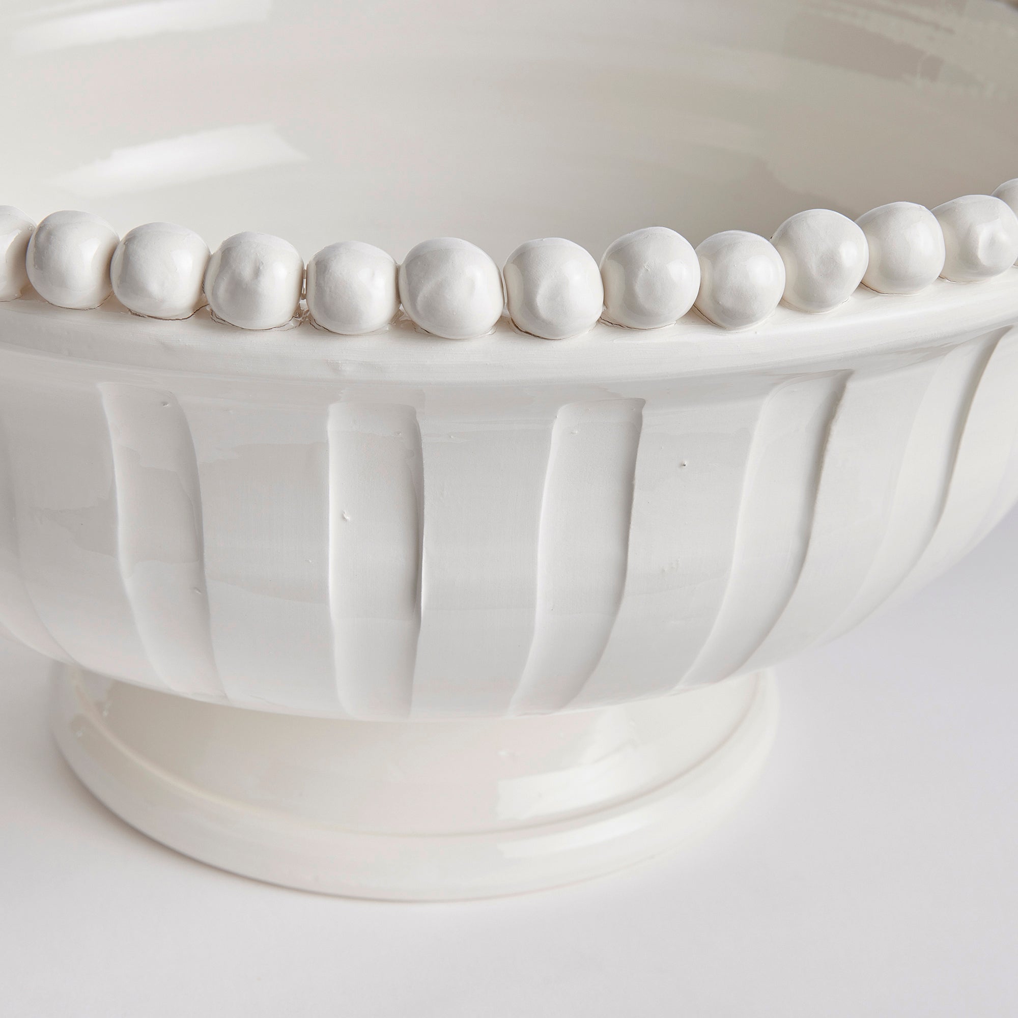 The Coletta Decorative Footed Low Bowl is handmade by Italian artisans in Tuscany, Italy. The subtle ribbing and hand-applied beading are made with genuine attention to detail. With a classic Italian craftsmanship passed down through generations, each piece is a true original. Amethyst Home provides interior design, new construction, custom furniture, and area rugs in the Des Moines metro area.