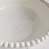 The Coletta Decorative Footed Low Bowl is handmade by Italian artisans in Tuscany, Italy. The subtle ribbing and hand-applied beading are made with genuine attention to detail. With a classic Italian craftsmanship passed down through generations, each piece is a true original. Amethyst Home provides interior design, new construction, custom furniture, and area rugs in the Portland metro area.