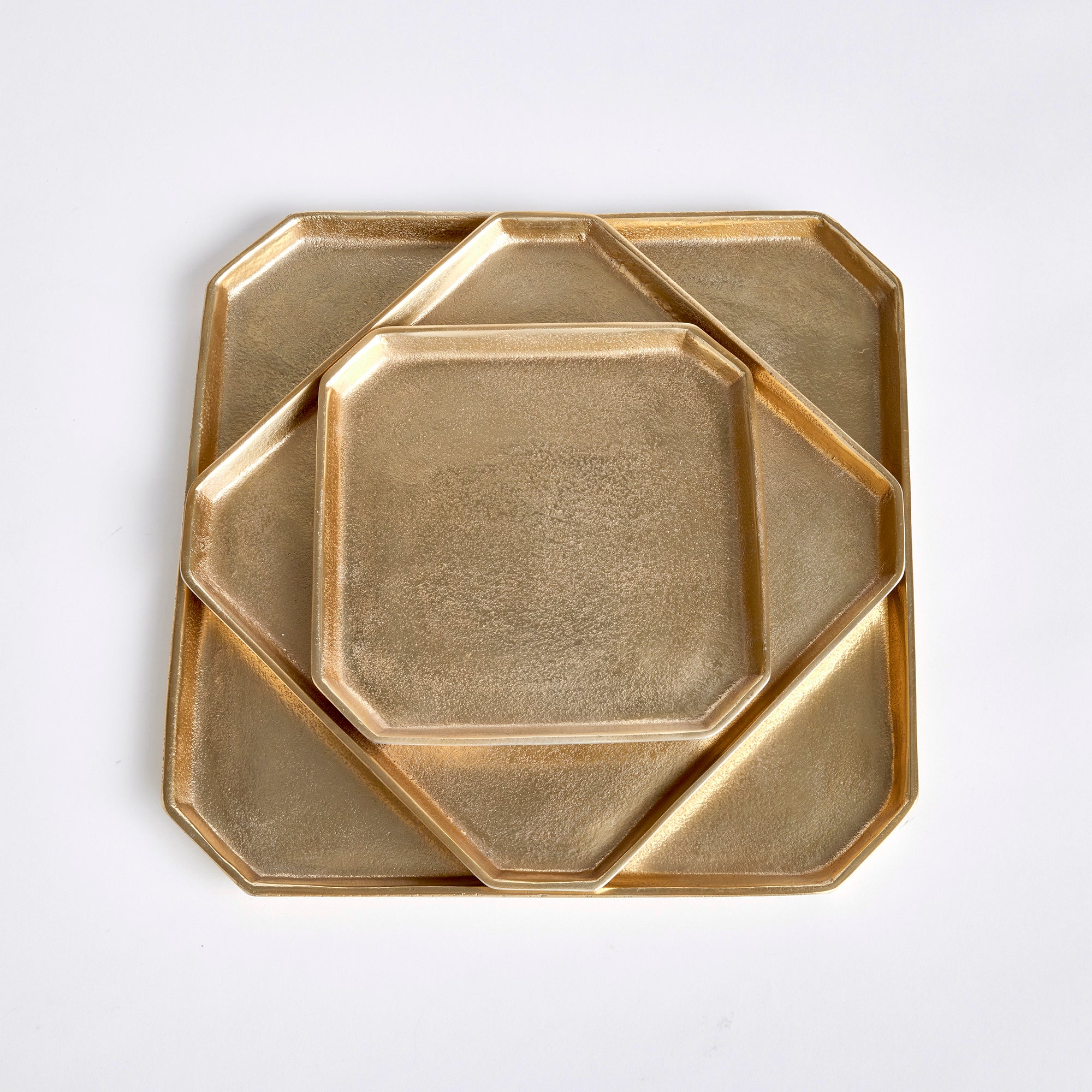 A geometric shape and sleek look make these cast aluminum trays unique. Line with a collection of candles for a golden, contemporary touch. They are dry food safe, so serve your favorite muffins or rolls in style at your next gathering. Amethyst Home provides interior design, new construction, custom furniture, and area rugs in the Monterey metro area.
