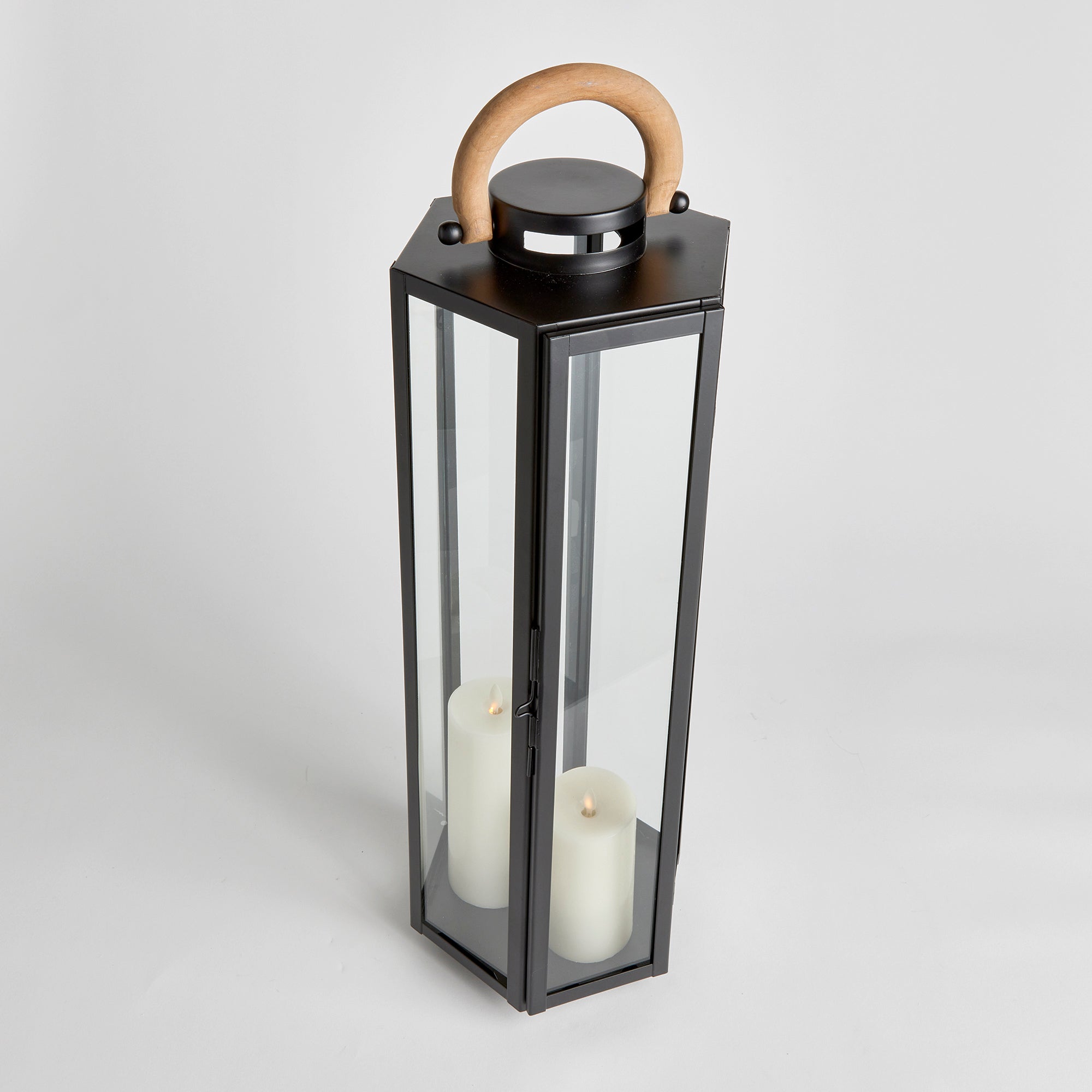 This matte black six panel lantern is made of iron and features a natural teak handle. Impressive in scale, it is a handsome outdoor accent by the pool, or at the front entry. Amethyst Home provides interior design, new construction, custom furniture, and area rugs in the Omaha metro area.