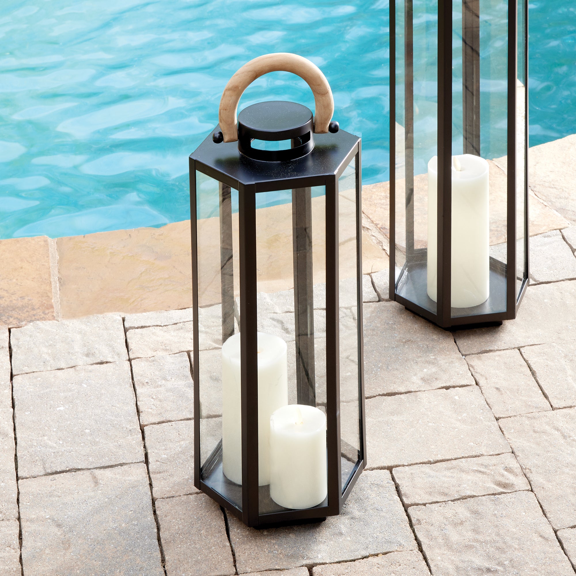 This matte black six panel lantern is made of iron and features a natural teak handle. Impressive in scale, it is a handsome outdoor accent by the pool, or at the front entry. Amethyst Home provides interior design, new construction, custom furniture, and area rugs in the Portland metro area.
