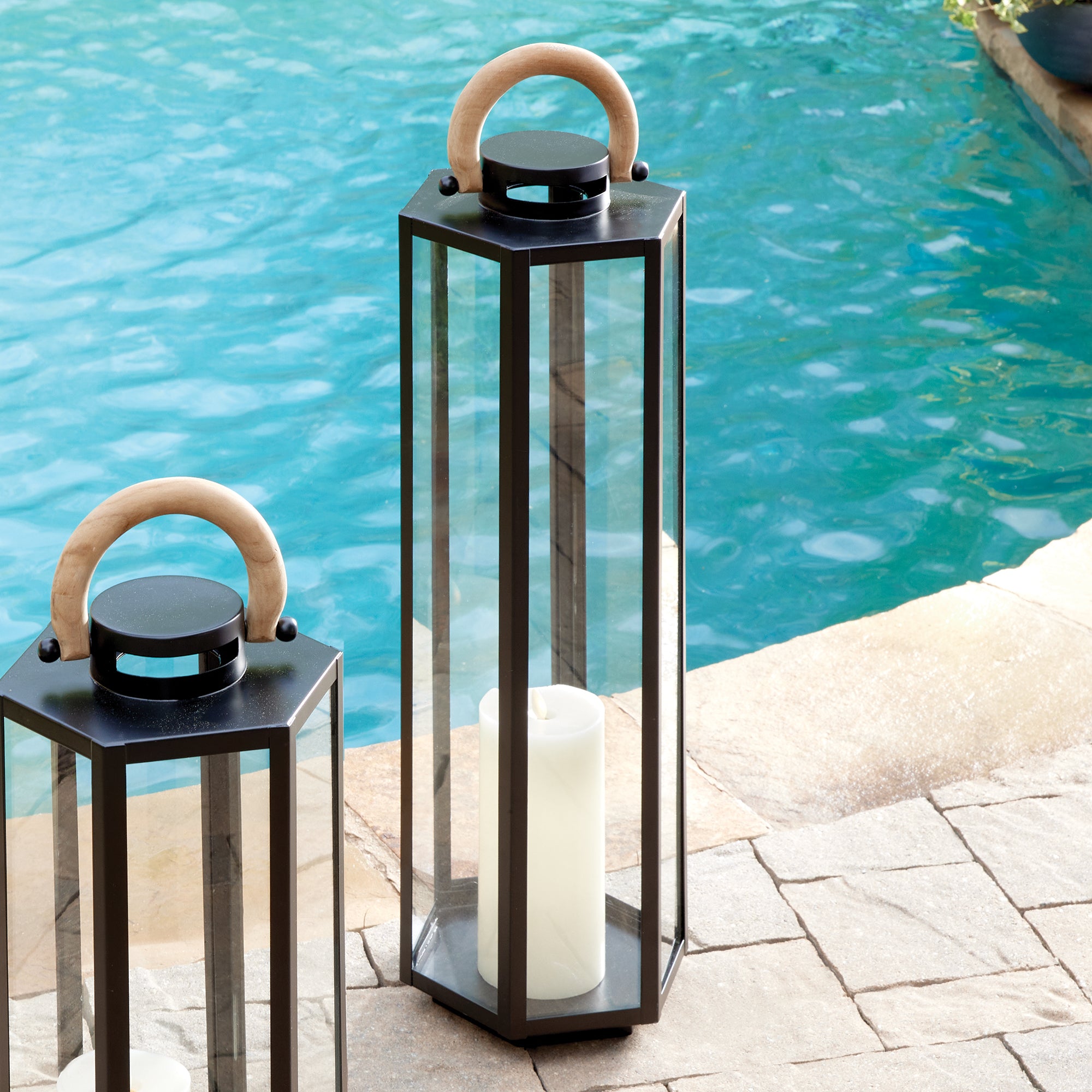 This matte black six panel lantern is made of iron and features a natural teak handle. Impressive in scale, it is a handsome outdoor accent by the pool, or at the front entry. Amethyst Home provides interior design, new construction, custom furniture, and area rugs in the Los Angeles metro area.
