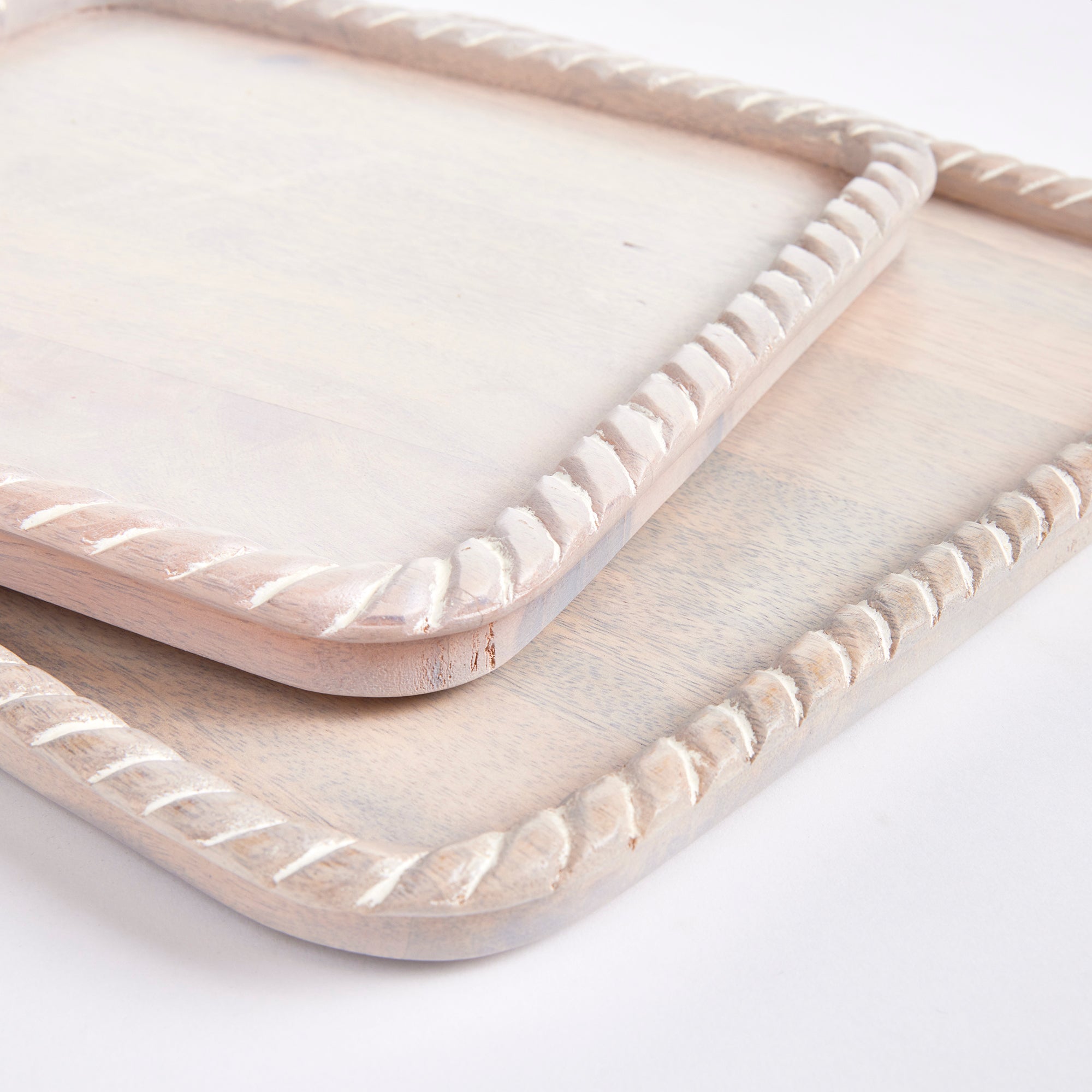 Hand carved from mango wood, this pair of trays is a sweet little accent for baked goods or a cheese tray. A little touch of natural wood tone is always on trend. Amethyst Home provides interior design, new construction, custom furniture, and area rugs in the Monterey metro area.