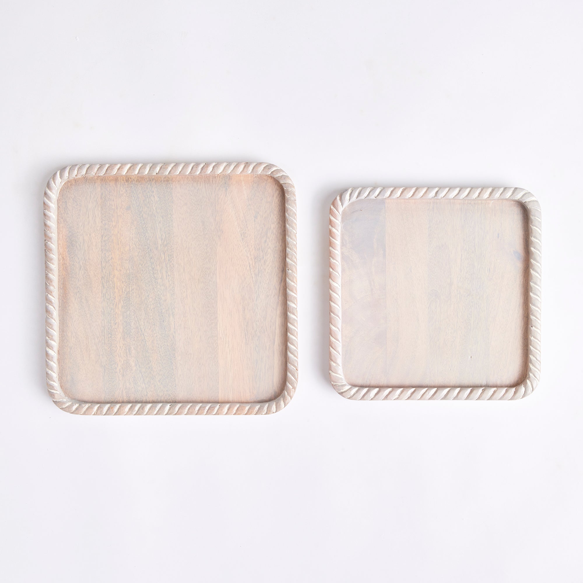 Hand carved from mango wood, this pair of trays is a sweet little accent for baked goods or a cheese tray. A little touch of natural wood tone is always on trend. Amethyst Home provides interior design, new construction, custom furniture, and area rugs in the Tampa metro area.