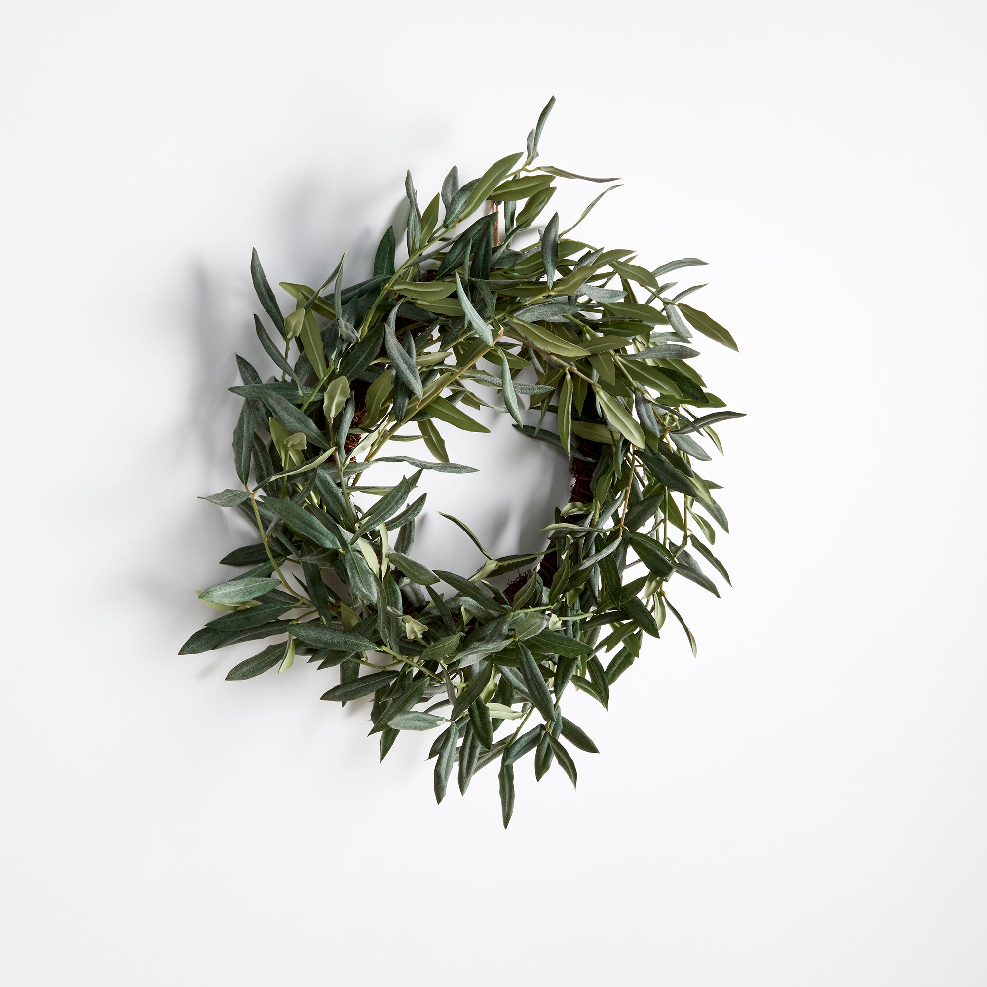 This olive wreath is a charming addition to any space needing a touch of warmth. Distinctive and refined, it's no wonder this Mediterranean beauty has stood the test of time. Comes complete with a twine loop for easy hanging. Use as a candle centerpiece on a table or hang on an interior door. Amethyst Home provides interior design, new construction, custom furniture, and area rugs in the Alpharetta metro area.