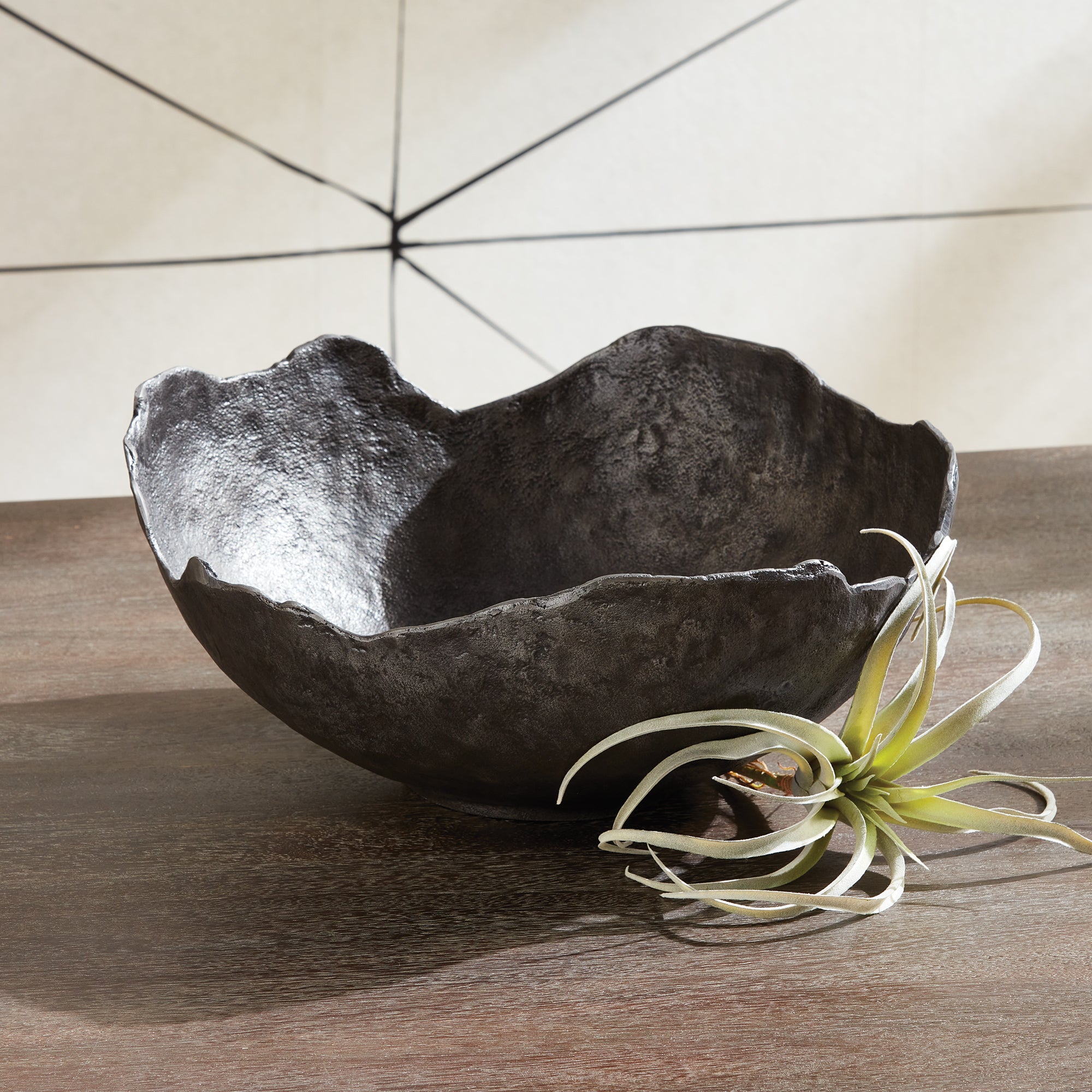 This decorative hand-sculpted bowl is made to be on display. With an oil-rubbed bronze finish and irregular edge, styled or just as it is, a strong statement for the modern space. The epitome of functional art. Amethyst Home provides interior design, new construction, custom furniture, and area rugs in the Boston metro area.