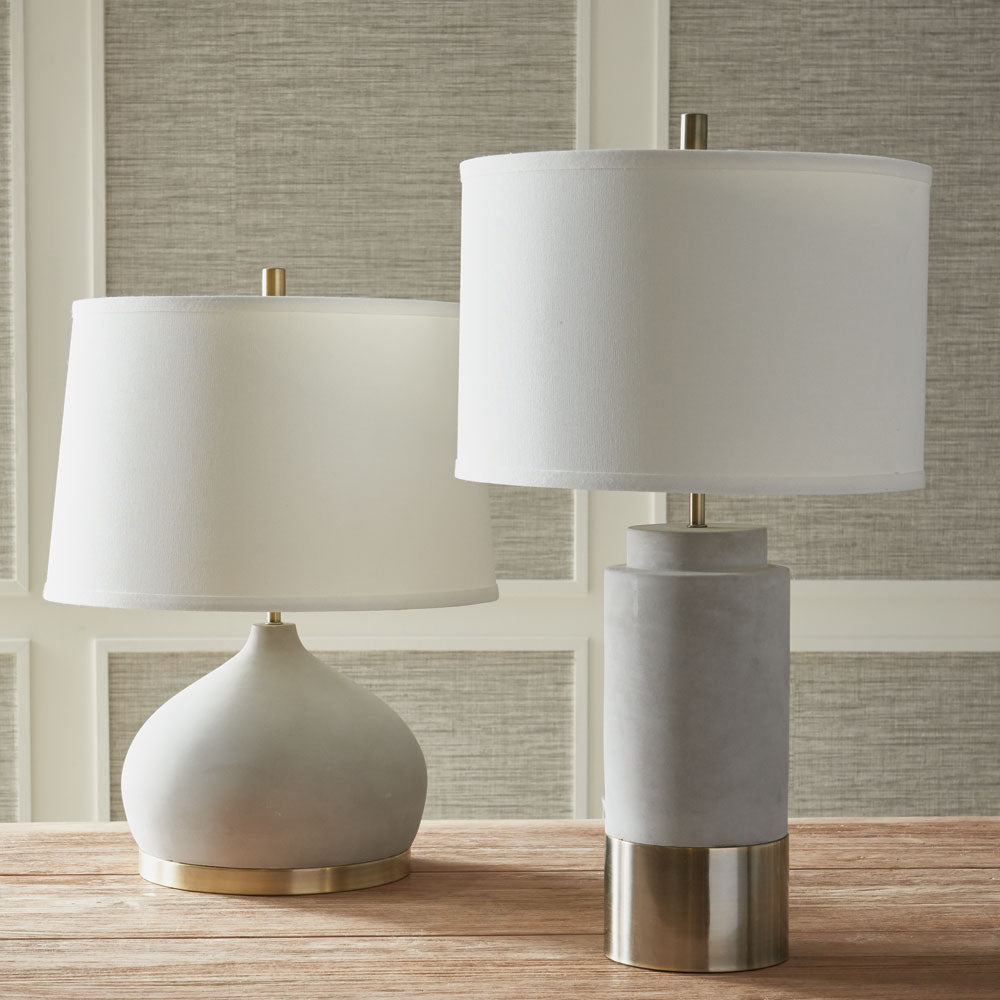 An unexpected mix of cement and brass accents make the Suki lamp a stand out fixture. Extra curvy base and wide shade are details that add style and personality. Amethyst Home provides interior design, new construction, custom furniture, and area rugs in the Alpharetta metro area.