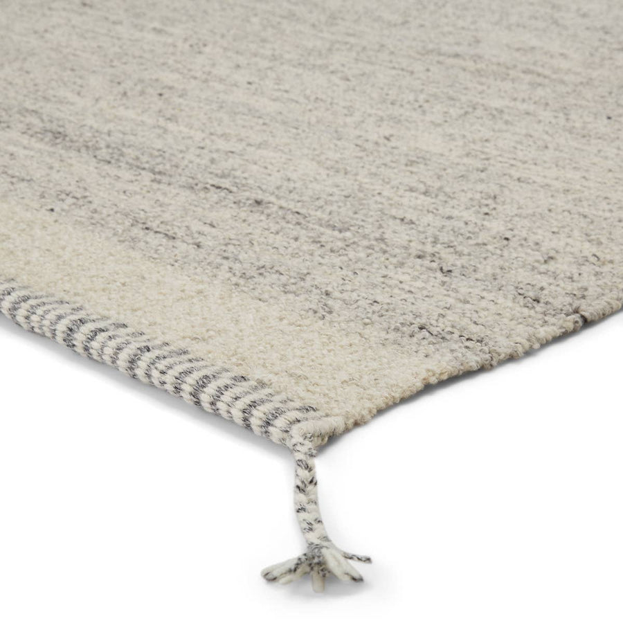 The Nazca Gila Area Rug, or NAZ03, by Jaipur is hand-loomed of texture-rich wool. The Gila area rug boasts a gray and ivory colorway, while the linear border with braided tassel details on each corner give it beautiful, unique touch. This is a perfect rug for a living room, bedroom, or other high-traffic areas