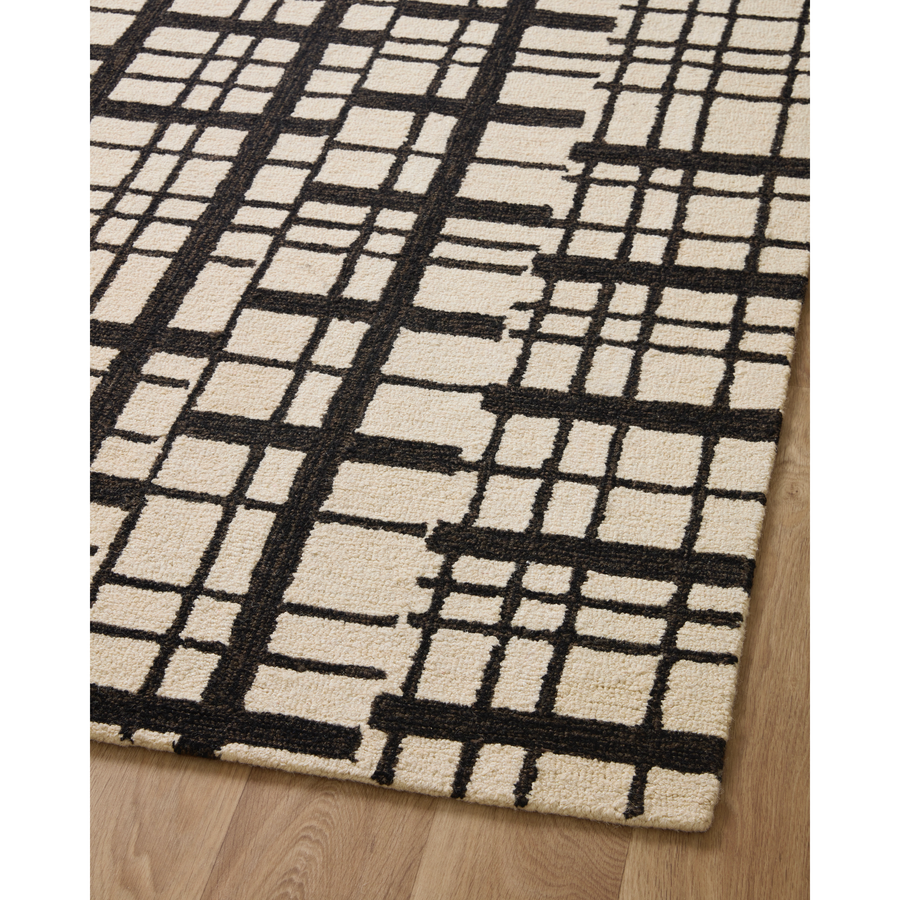 Hand-tufted of wool and jute pile, the Polly POL-02 CJ Black / Ivory rug for Chris Loves Julia x Loloi brings a fresh take on modern yet classic designs. With striking gridded designs toned down by a neutral color palette, Polly is a timeless choice for any room. Amethyst Home provides interior design, new construction, custom furniture, and rugs for the Des Moines metro area.