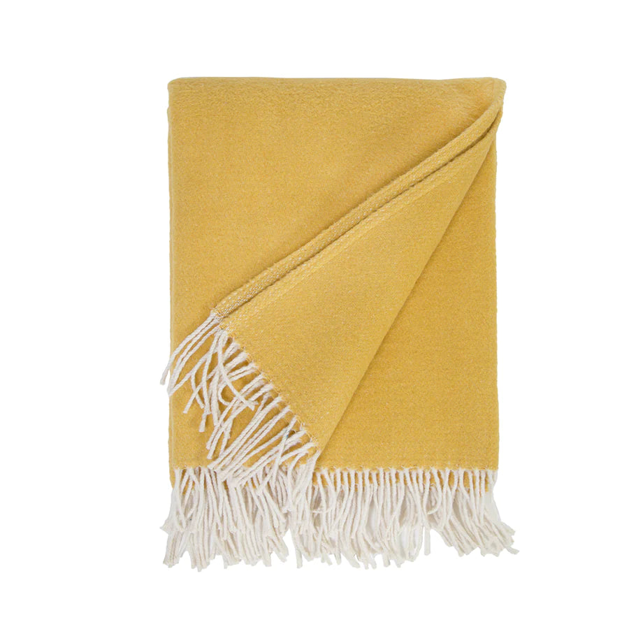 Cozy combed cotton Billie Mustard Throw with a soft ivory interwoven weave ending in tassels.  Amethyst Home provides interior design services, furniture, rugs, and lighting in the Miami metro area.