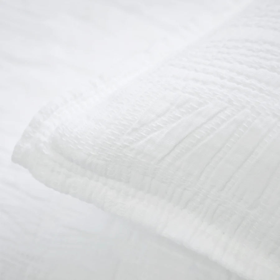 The Harbour White Matelasse Sham features an abstract, geometric weave making it a modern matelasse. The matelasse achieves a beautiful texture without any batting. Amethyst Home provides interior design services, furniture, rugs, and lighting in the Omaha metro area.