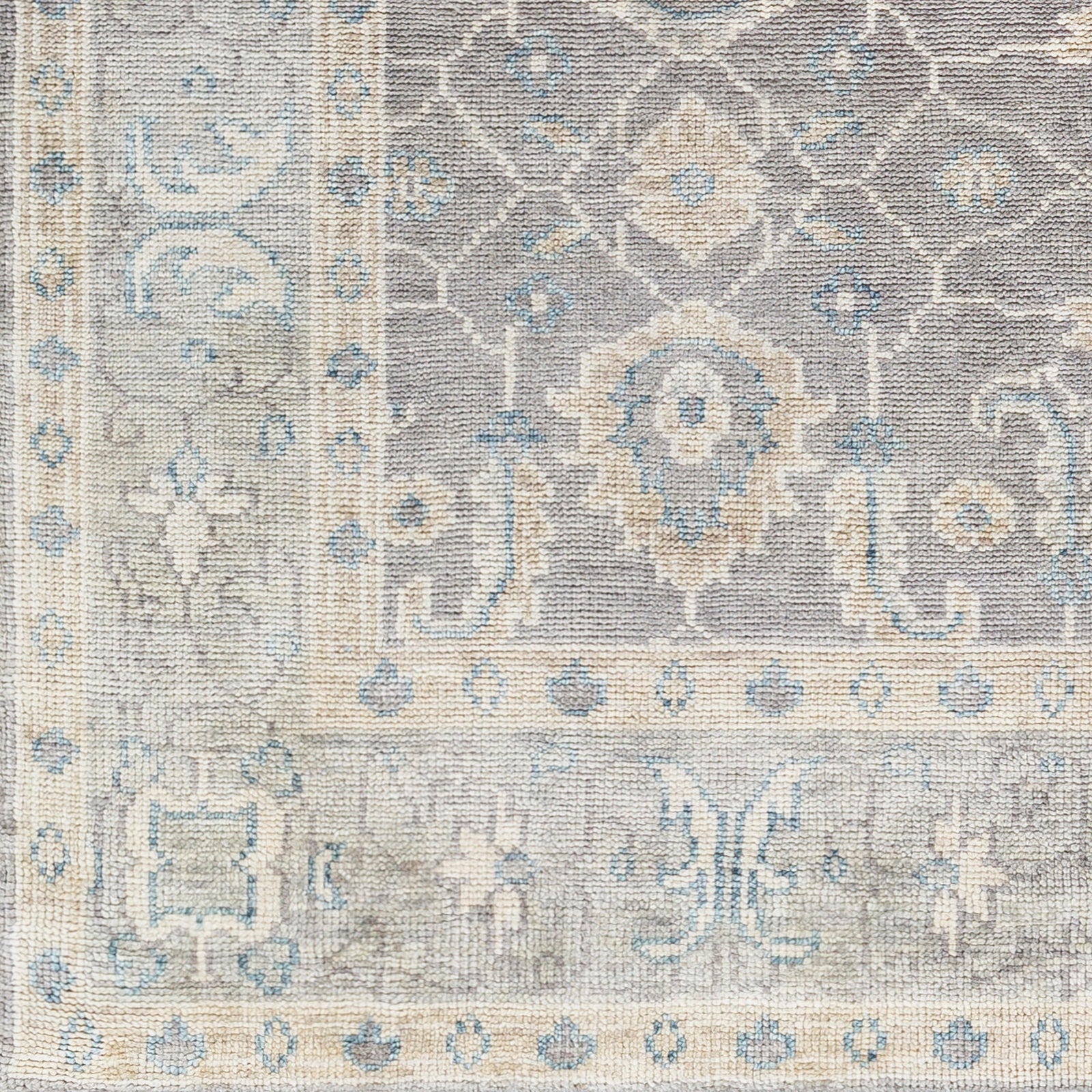 Give your space an air of sophistication with our Palais Hand-Knotted Rug. Crafted with 100% wool in hues of charcoal, ivory, seafoam, and taupe, the rug features a soft texture and is contrasted with a deep center and bright border for an artful look. Perfect for adding depth and character to any room. Amethyst Home provides interior design, new construction, custom furniture, and area rugs in the Hamptons metro area