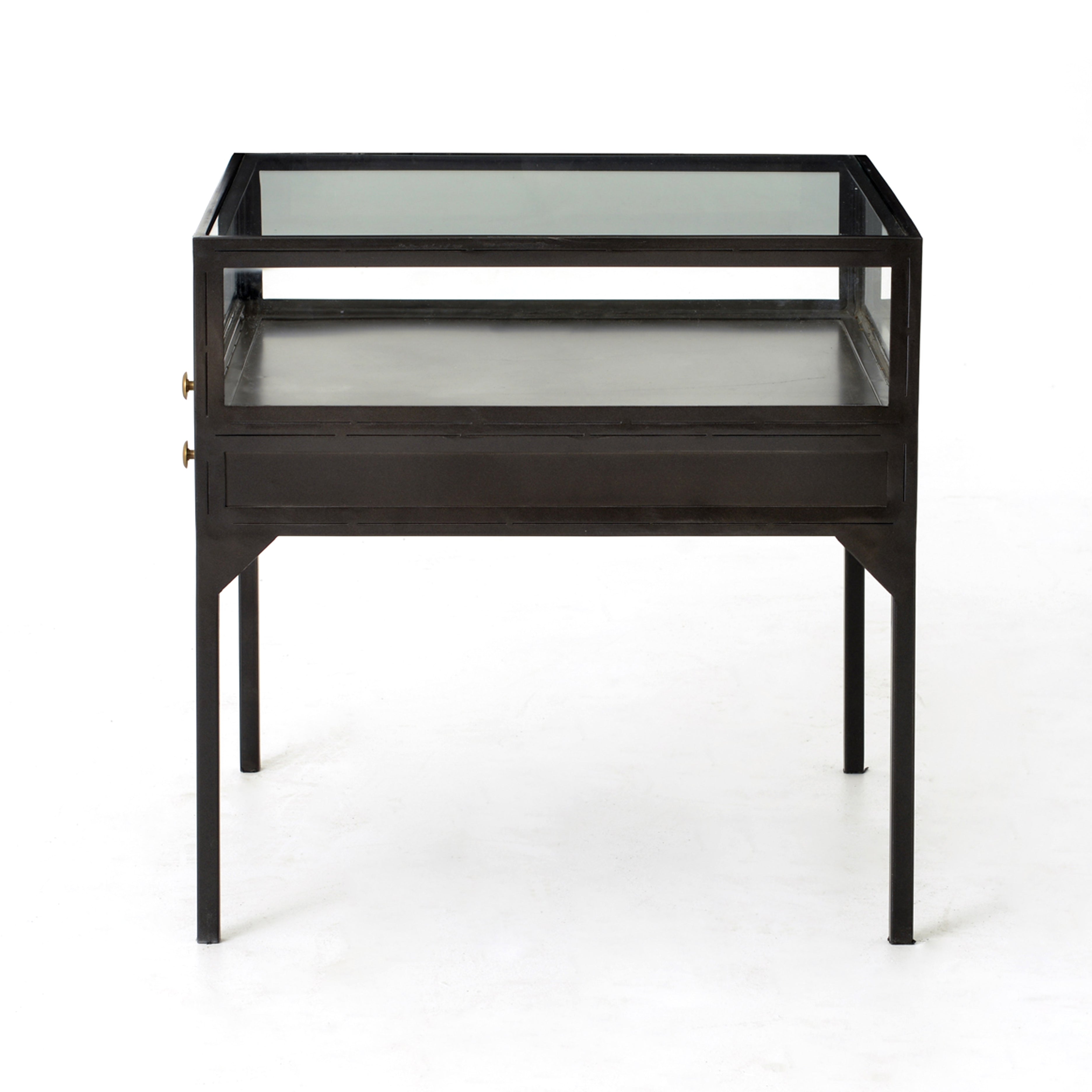 A shadowbox-inspired end table gives your inner collector a place to play. Frame prized possessions in a glass enclosure with matte-black metal and brass knobs. The perfect end table for a bed or sofa!