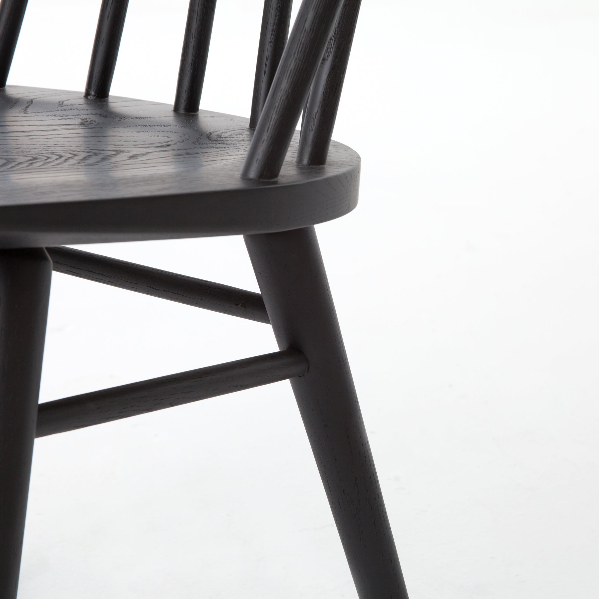 Try a cleaner, more modern take on the traditional Windsor with our Windsor Dining Chair. This tall beauty is wire-brushed to bring out the cathedral grain in the oak, and stained deep black for lovely contrast with more industrial decor. This chair is perfect for a dining room or that special nook in your home.
