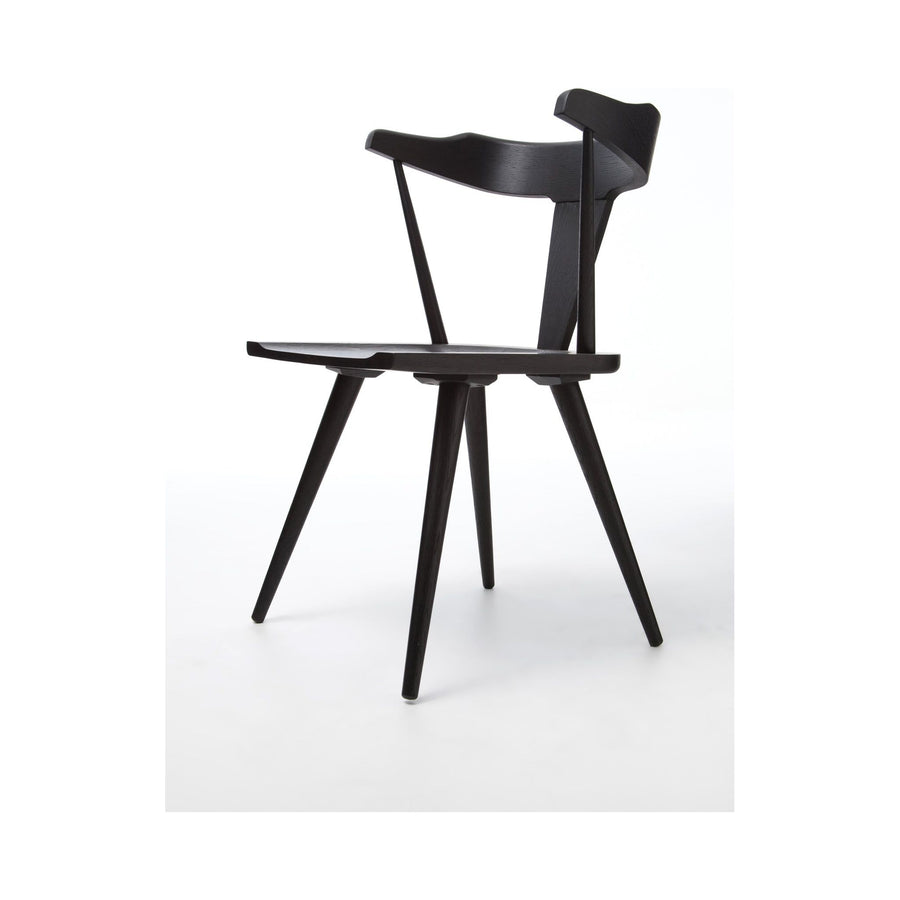 This new take on the mid-century Windsor chair, the Ripley Dining Chair has a bowed, sculptural silhouette. A soft black finish adds movement to the wood by highlighting the natural grain of weathered oak. The chair is perfect for the chic, modern dining room look.