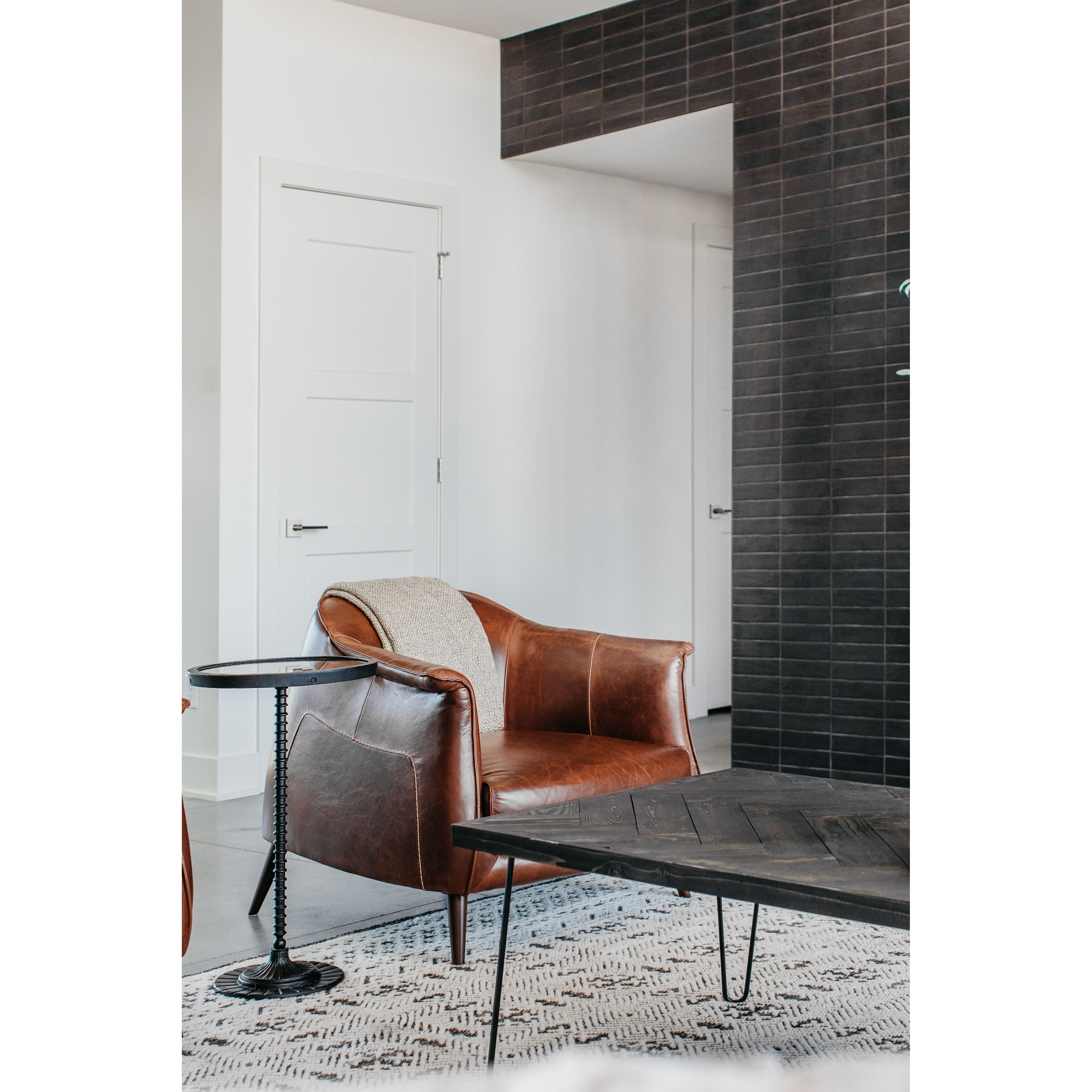 The Victor leather chair instantly transforms any living room into an infinitely sophisticated space. The tan leather upholstery and gently curved back are both chic and superbly comfortable. The chair is supported by a pocketed coil spring seating on solid oak wood legs for added durability.
