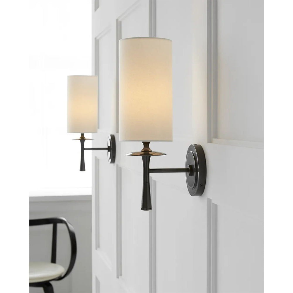 The Drunmore Single Sconce by AERIN combines traditional design with contemporary detailing. The modern design is finished in solid bronze or bronze with crystal detailing, and the elongated shade in either linen or white glass casts abundant illumination for hallways or bathrooms. Ideal as a pair or in multiples Amethyst Home provides interior design, new home construction design consulting, vintage area rugs, and lighting in the Winter Garden metro area.