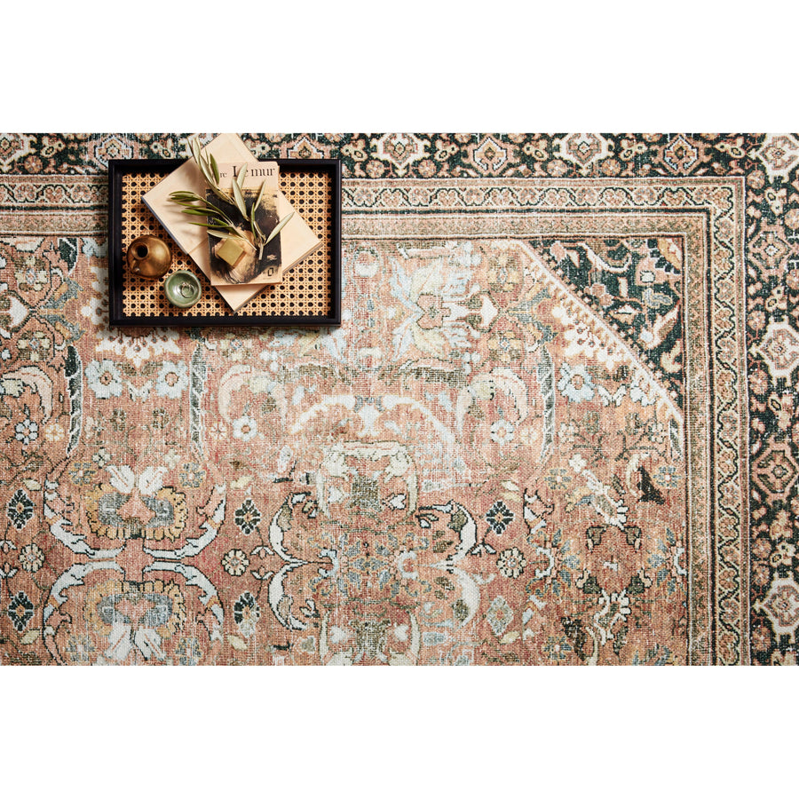 The Wynter Auburn / Multi area rug showcases a one-of-a-kind vintage or antique area rug look power-loomed of 100% polyester. This rug brings in tones of orange, brown, black, and hints of blue. The rug is ideal for high traffic areas such as living rooms, dining rooms, kitchens, hallways, and entryways.