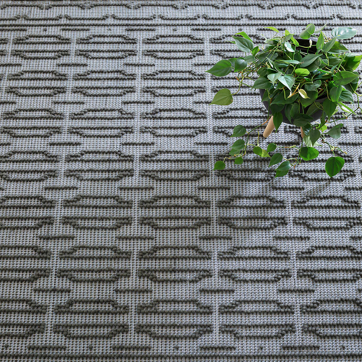 The Campbell Iron Rug relief pattern plays across a gently marled woven wool ground, accentuating the graphic dimension created by the different weaves. The central motif is repeated inversely to create a border around this sumptuous rug. Amethyst Home provides interior design services, furniture, rugs, and lighting in the Miami metro area.