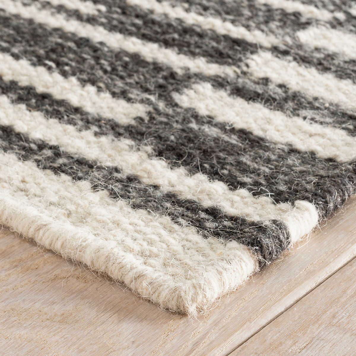 The Heights Charcoal Rug creates the illusion of layers with this gorgeous chunky, flatwoven wool rug. Concentric rectangles of offset ladder stripes make a bold graphic statement. Hand-loomed by artisans from undyed natural fleece wool in marled shades of Charcoal and Ivory. Amethyst Home provides interior design services, furniture, rugs, and lighting in the Salt Lake City metro area.