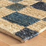 Connect to the earth with the relaxed aesthetic of a foundational rug, embodying a legacy of quality craftsmanship and elegant modernity. Soothing shades of calm, inspired by nature's harmony, form a bold rhythmic geometric composition. Durably woven with sustainable jute in a deeply textured, playful variegated patchwork. Amethyst Home provides interior design services, furniture, rugs, and lighting in the Salt Lake City metro area.