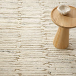 The Malone Oatmeal Rug is additionally emphasized by higher sheared tufts that contrast in color, sheen, and texture with dense and low looped stripes. A natural undyed fleece pile enhances the finely observed irregular striations. With modern and traditional elements, this sophisticated hand-knotted wool rug demonstrates unique textures found in nature. Amethyst Home provides interior design services, furniture, rugs, and lighting in the Seattle metro area.