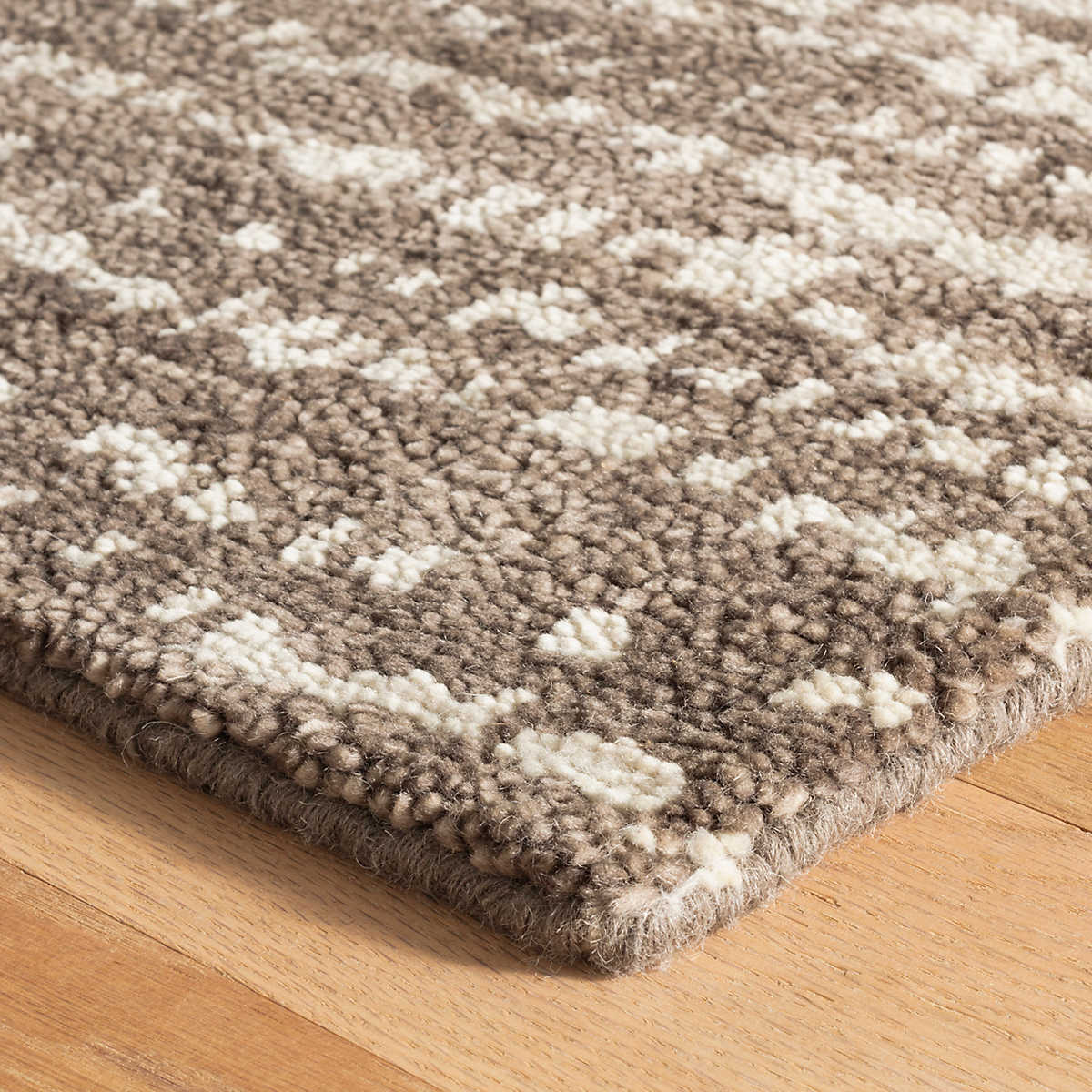 The Shepherd Grey Rug deeply dense and cushy pile serves to highlight the beauty of the unbleached color variations of natural wool fleece. The random stippling of irregularly shaped splotches is a signature motif of Marie Flanigan, an award-winning interior designer. Amethyst Home provides interior design services, furniture, rugs, and lighting in the Miami metro area.