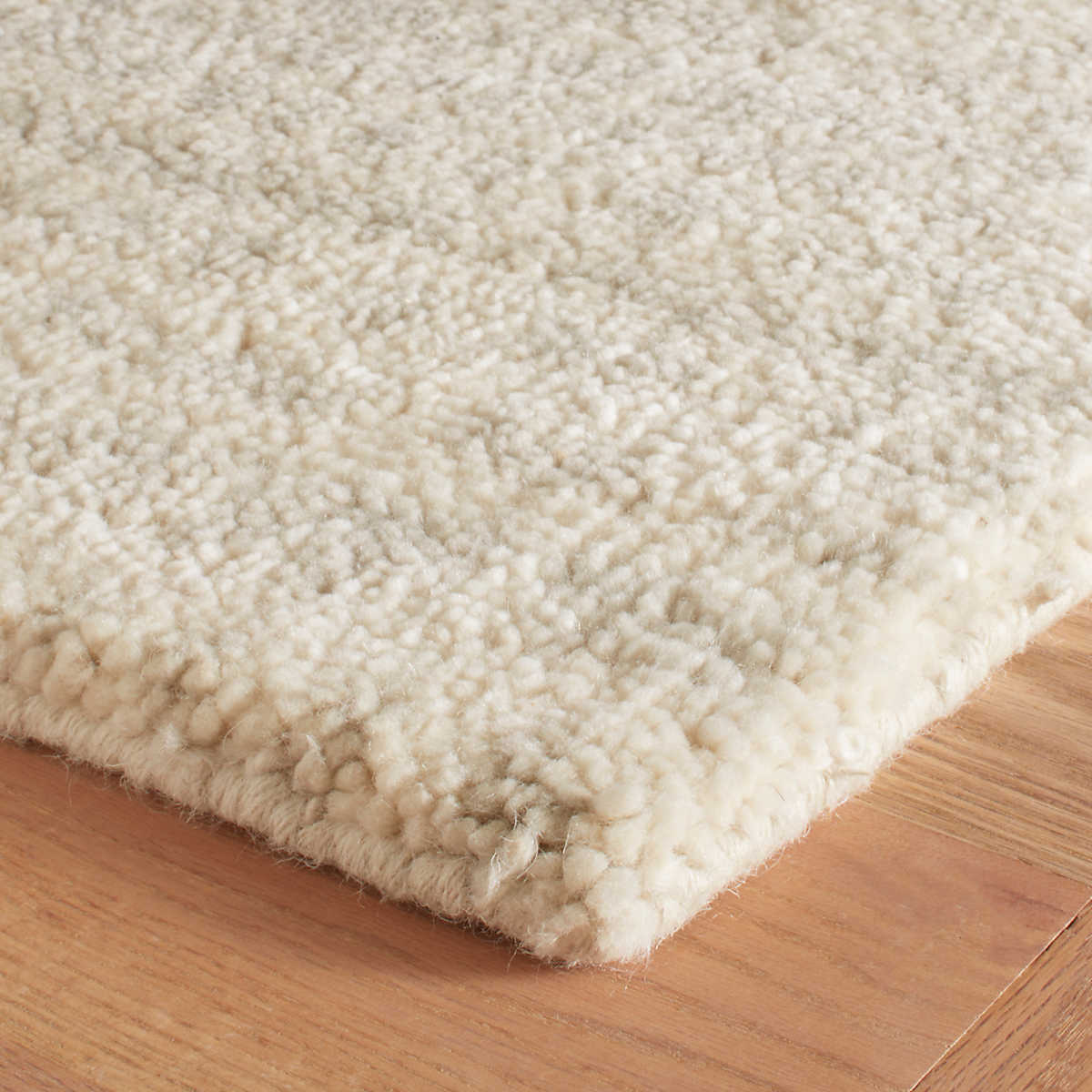 The Shepherd Plaster Rug deeply dense and cushy pile serves to highlight the beauty of the unbleached color variations of natural wool fleece. The random stippling of irregularly shaped splotches is a signature motif of Marie Flanigan, an award-winning interior designer. Amethyst Home provides interior design services, furniture, rugs, and lighting in the Omaha metro area.
