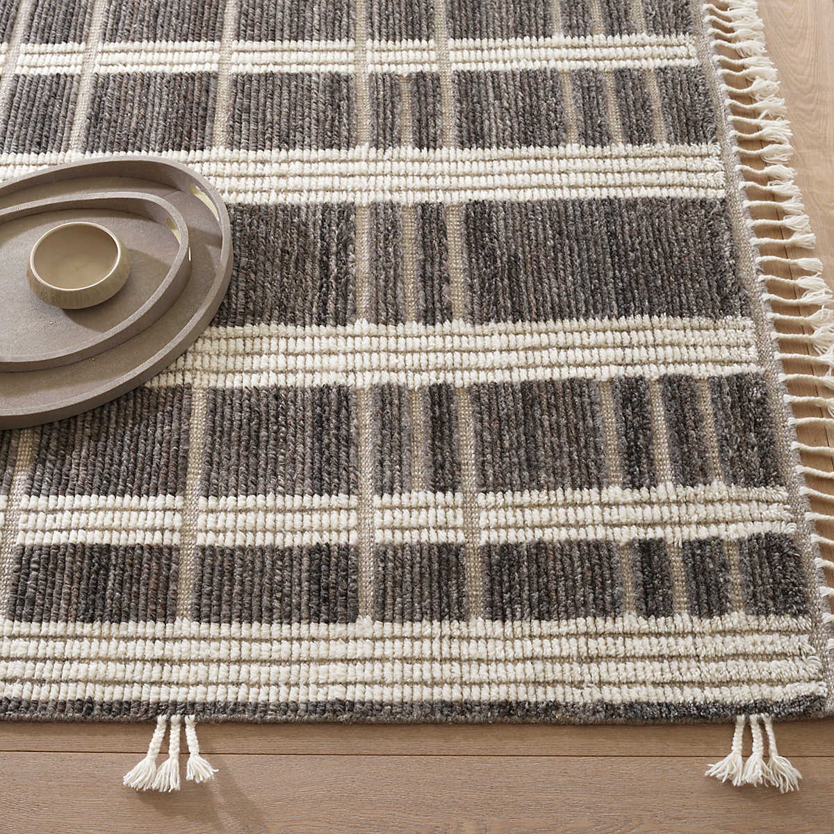 The Tory Grey/Ivory Rug stripes of Ivory fleece alternate with raised bands of naturally colored, mélange Charcoal wool. Interspersed by low-profile, woven taupe boundaries that bring rhythm to the textural blocks. Length sides are lightened with funky, bohemian braided tassels that add whimsy. Amethyst Home provides interior design services, furniture, rugs, and lighting in the Miami metro area.