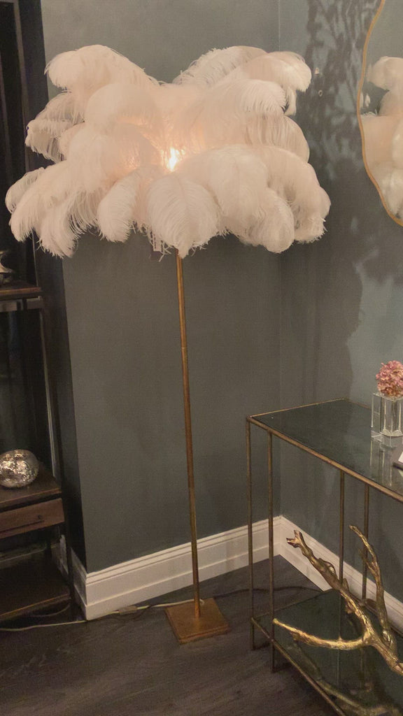 Feather your nest with the Josephine Floor Lamp, romantic and feminine this sultry lamp will make a statement in your bedroom or living room. It's elegant gilded gold base supports real Ostrich feathers.    Overall Dimensions: 35"w x 35"d x 70"h