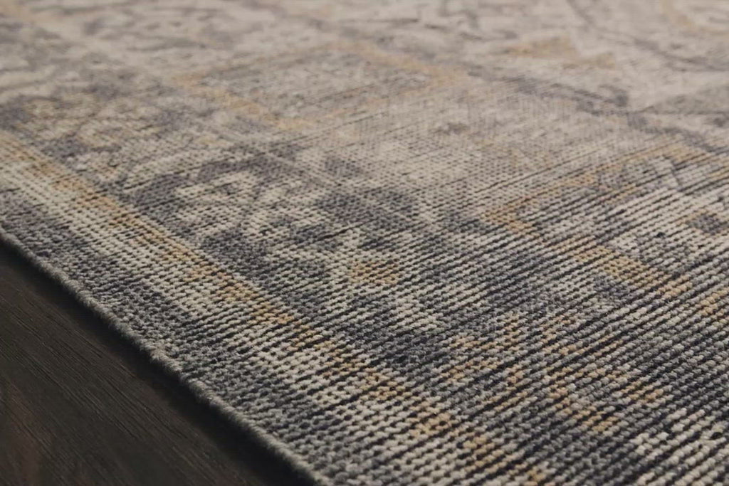 Bring a touch of antiqued beauty into your home with the Heirloom Bone / Charcoal rug from Loloi. This wool rug tastefully honors the art of hand knotted rugs. The rug evokes a sense of unique sophistication with its traditional Serapi rug color palettes and vintage design.