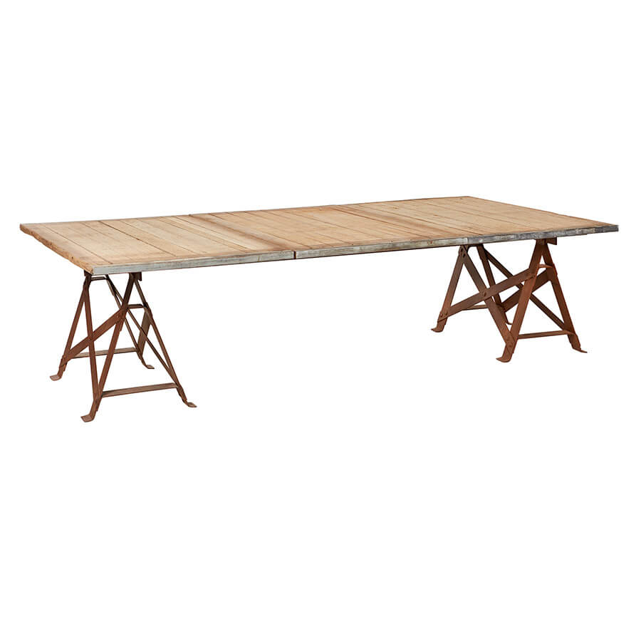 Preserving naturally rustic imperfections, the Brickmaker XL Dining Table provides an unexpected statement to any dining room or patio collection. Laid with 3 reclaimed azobe wood pallets, each panel maintains its own unique character of intriguing watermarks and decorative scars. This trestle table has two waxed rust iron legs that contrast handsomely with its rudimentary table top. The Brickmaker Dining Table is an ageless and raw find  Size: 55.5" w x 130" l x 30" h  Materials: Salvaged azobe wood, steel