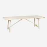 The Campaign Dining Table is a gorgeous light whitewashed color made of natural pine. The legs have a unique, geometric shape and is sure to make a statement in any dining room.  Size: 96"w x 30"h x 36"d Materials: Pine 