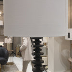 Textured bands ripple down the graduated column of our sculptural Fishbone floor lamp. Corrugated birch wood is handcrafted by artisans and balanced with a natural linen shade. This elegant profile makes a simple yet stunning statement to any living room, bedroom or den.  Size: 67"h x 21.5"w x 21.5"d