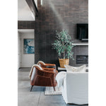 The Victor leather chair instantly transforms any living room into an infinitely sophisticated space. The tan leather upholstery and gently curved back are both chic and superbly comfortable. The chair is supported by a pocketed coil spring seating on solid oak wood legs for added durability.