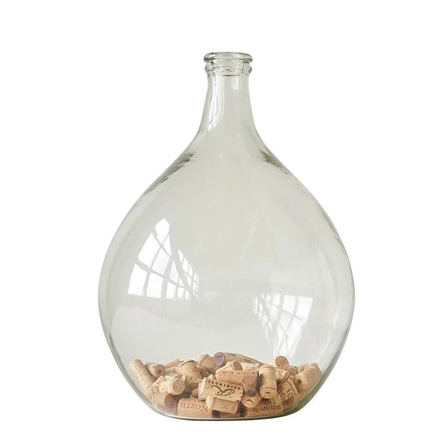 This Decorative Glass Bottle 12" is the perfect addition to any shelf or center piece. There is a 1.5 in. round opening to slide your items inside and keep them nestled together in the bottom. Fill it with a collection of sentimental items or leave it empty.  Size: 12" dia x 18.5"H  Glass Bottle
