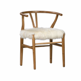 Dramatic and bold! This Baker Dining Chair is perfect for adding fun style to your space.  Has a wishbone styled frame and the fur seat is soft, plush and eye-catching.  GOAT SKIN NATURAL WHITE AND OAK WOOD SNOW WHITE AND ANTIQUE BROWN FINISH LEGS Size: 22"l x 23"d x 31"h