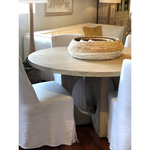 We love the unique cut out base of this Elaine Round Dining Table. Made from reclaimed solid pine, each piece will be unique to your home + bring an organic feel to any dining room or kitchen area.  Reclaimed Solid Pine Light White Wash Sealed Finish