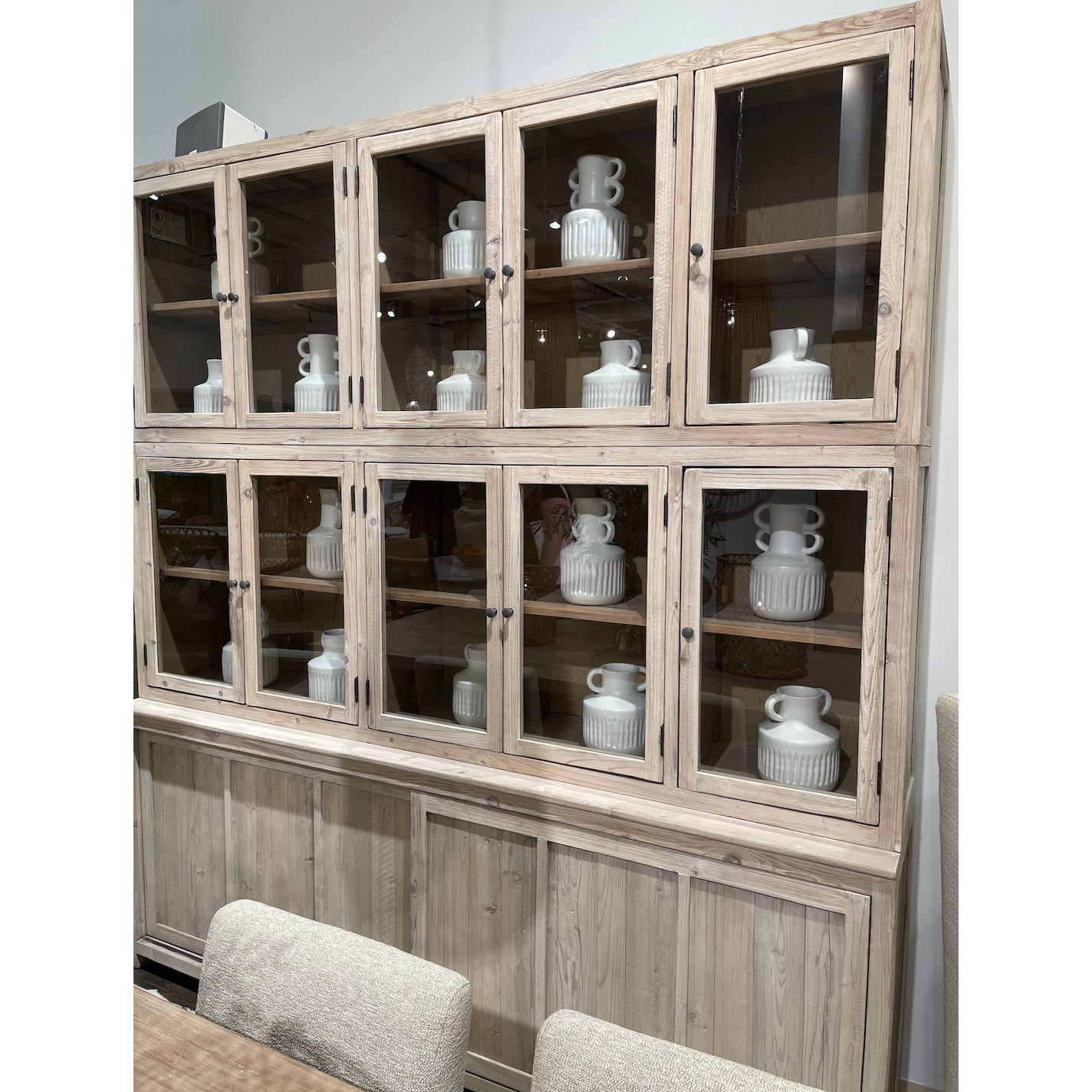 This Haley Cabinet has ample storage, with glass door panels opening to shelves and a bottom sliding door that opens to more shelves. Made from reclaimed pine with a white wash grey sealed finish, this brings an antique feel to any room.  Reclaimed Pine  White Wash Grey Sealed Finish  Flat Glass Door Panels