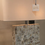 We love that this Bliss Mother of Pearl Table Lamp is covered in mother-of-pearl tiles and set on a clear crystal base. The Bliss Table Lamp brings refinement and sophistication to any space. A white linen rectangle shade completes the design.   Overall Dimensions: 17"w x 7"d x 22.5"h