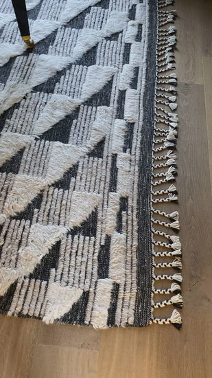 A nod to timeless Moroccan style, the Khalid Collection is hand-knotted in India by skilled artisans. The soft pile features 100% natural, undyed wool, lending slight variations in tones that make each piece it's own. Plus, each rug is finished with a thoughtfully designed fringe.  Hand Knotted 100% Wool KF-02 Natural/Black