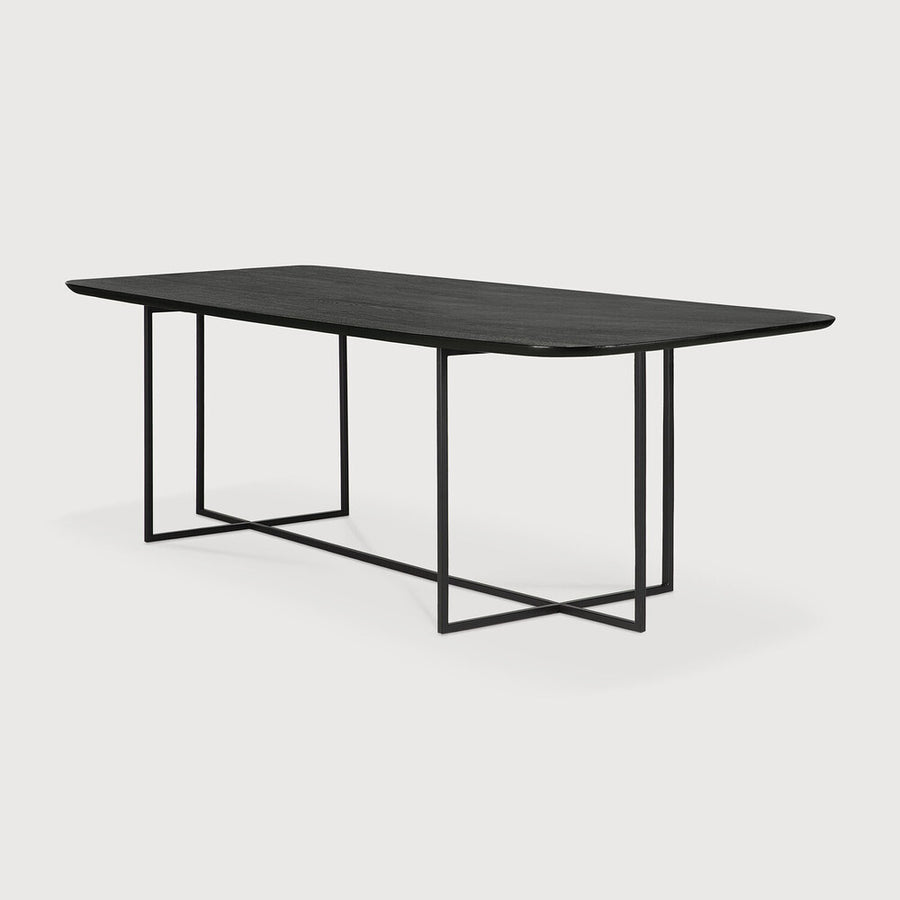 We love the combination of the tapered black metal leg base against a brushed black Oak finish on this Oak Arc Dining Table - Black.  With a slightly rounded tabletop, this brings a contemporary look to any dining room or kitchen area. Designed by Alain Van Havre.  Material: Oak, 100% Solid Wood Finish: Varnished